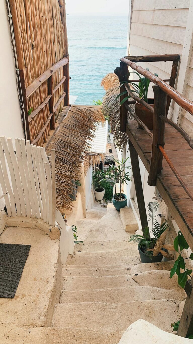 Explore a serene staircase leading to a stunning sea view from a cliffside villa in Bali, Indonesia.