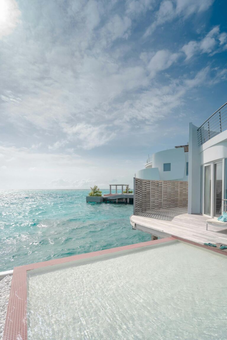 Stunning oceanfront villa with an infinity pool and clear blue skies.